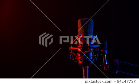 Professional microphone in pink smoke on a black background. Professional microphone in pink smoke on a black background. 84147757