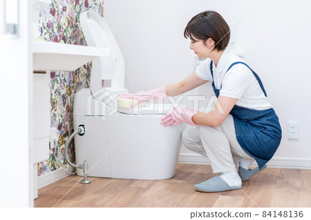 Young house cleaning woman cleaning the toilet 84148136