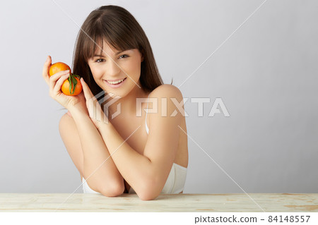 wellness woman with tangerine in her hands wellness woman with tangerine in her hands 84148557