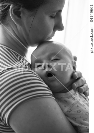 Caucasian mother holding her newborn baby girl spending time together 84149661