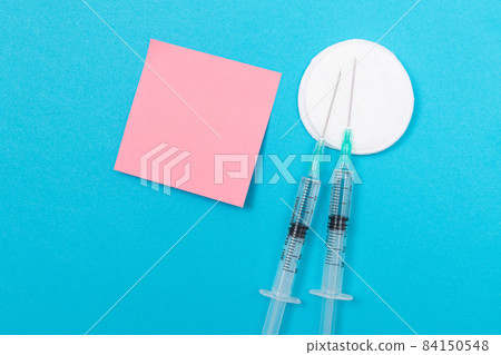 Vaccination or Revaccination Concept - Two Medical Syringe on Blue Table 84150548