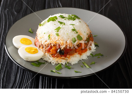 Arroz tapado is a classic Peruvian layered rice and ground beef dish close up in the plate. Horizontal Arroz tapado is a classic Peruvian layered rice and ground beef dish close up in the plate. Horizontal 84150730