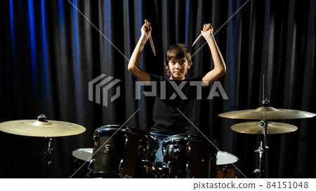A boy plays drums in a recording studio 84151048