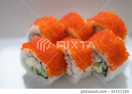 Sushi with orange flying fish caviar on a white plate 84151184