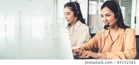 Business team wearing headset working actively in office 84152383