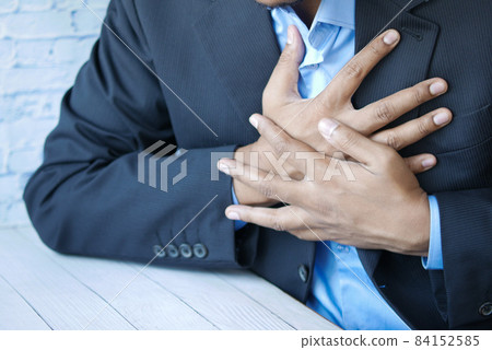 young man suffering pain in heart and holding chest with hand young man suffering pain in heart and holding chest with hand 84152585