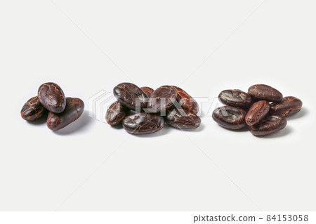 Few piles of raw organic cacao beans Few piles of raw organic cacao beans 84153058