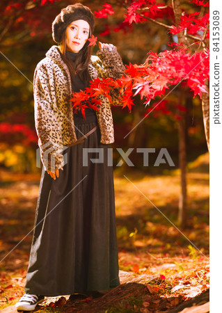 A cute girl in the autumnal maple forest 84153089