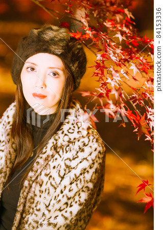 A cute girl under a maple branch at a high angle A cute girl under a maple branch at a high angle 84153336