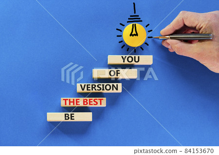 Best version of you symbol. Wooden blocks with words Be the best version of you on blue background, copy space. Light bulb icon. Businessman hand with pen. Business, best version of you concept. Best version of you symbol. Wooden blocks with words Be the best version of you on blue background, copy space. Light bulb icon. Businessman hand with pen. Business, best version of you concept. 84153670