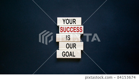 Wooden blocks with text 'your success is our goal'. Beautiful black background, copy space. Business concept. 84153674