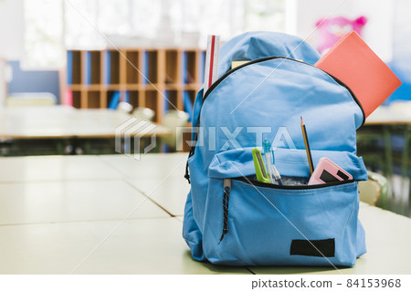 blue schoolchild backpack table. High quality beautiful photo concept blue schoolchild backpack table. High quality beautiful photo concept 84153968