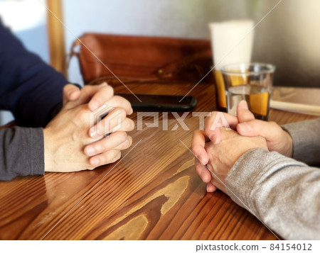 Hands of two women facing each other with their fingers crossed Hands of two women facing each other with their fingers crossed 84154012
