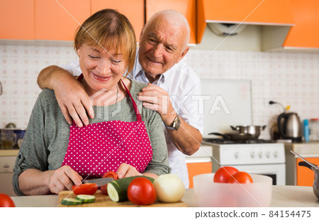 Happy aged couple cooking Happy aged couple cooking 84154475