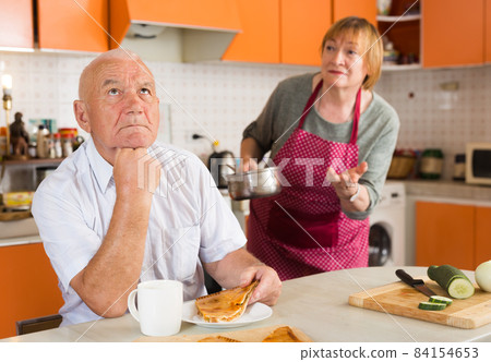 Upset senior man with disgruntled wife 84154653