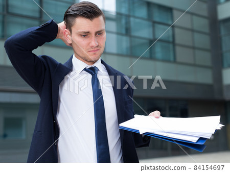 Man is standing upset near office Man is standing upset near office 84154697