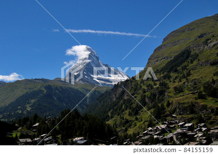 Impressive Matterhorn against the backdrop of the blue sky seen from Zermatt over the mountains on the right Impressive Matterhorn against the backdrop of the blue sky seen from Zermatt over the mountains on the right 84155159