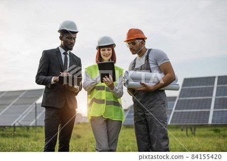 Multicultural people using tablet during work at solar farm 84155420
