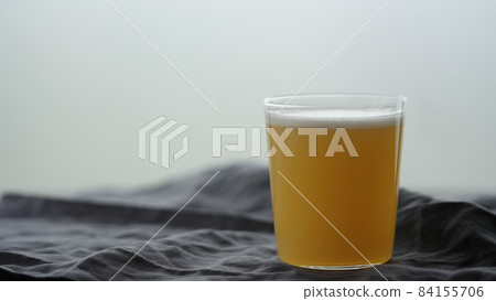 orange soft drink in tumbler glass on linen cloth orange soft drink in tumbler glass on linen cloth 84155706
