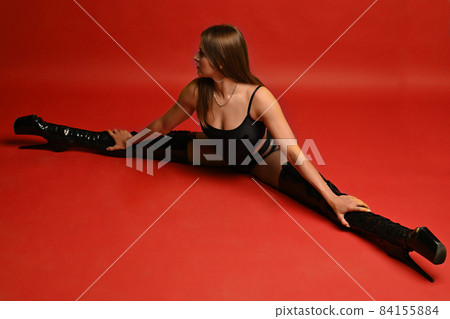 Beauty woman in Black shiny patent leather knee  84155884