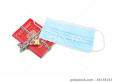 Passport with a medical mask on a white background. 84156153