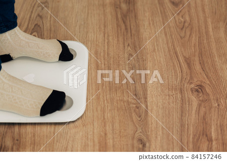 Girl Measures Weight on Smart Scales. Modern Electronic Device. 84157246