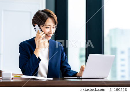 Career woman in the office to call Career woman in the office to call 84160238