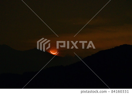 The red crescent moon of the earthlight rising in the Kanto Mountains, Hakushu-cho, Hokuto City 84160331