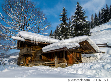 Old barn in the snowy landscape of Austria 84161971