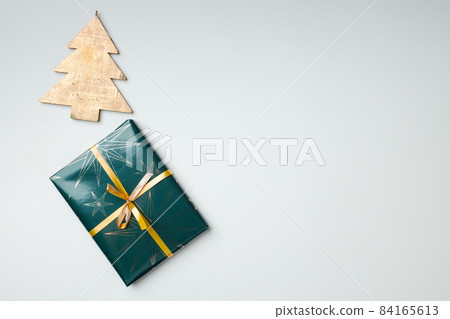 Christmas gift wrapped in paper with bow top view Christmas gift wrapped in paper with bow top view 84165613