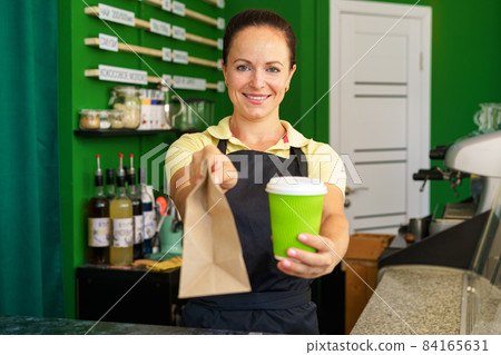 Portrait of a woman barista in coffee shop Portrait of a woman barista in coffee shop 84165631