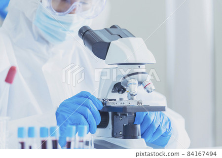 Male Scientist look into Microscope research in science laboratory. Asian scientist looking equipment laboratory chemistry labs. Covid-19 coronavirus biochemistry research experiment vaccine concept Male Scientist look into Microscope research in science laboratory. Asian scientist looking equipment laboratory chemistry labs. Covid-19 coronavirus biochemistry research experiment vaccine concept 84167494