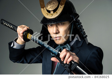 A businessman wearing a helmet that pulls out a sword 84168025