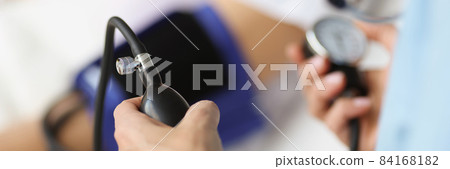 Doctor using tonometer checking blood pressure to patient in hospital Doctor using tonometer checking blood pressure to patient in hospital 84168182