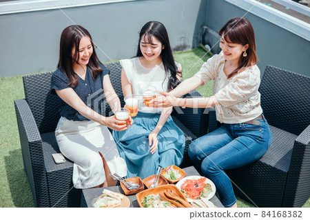 Women having a party on the roof (beer) Women having a party on the roof (beer) 84168382