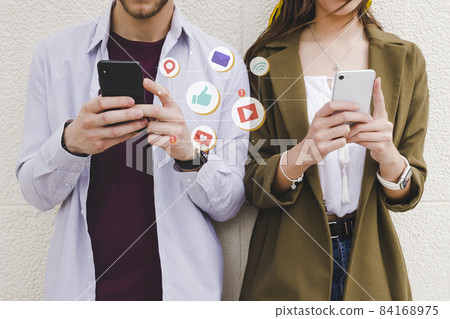 mobile notification icons man woman using cell phone. High quality beautiful photo concept mobile notification icons man woman using cell phone. High quality beautiful photo concept 84168975