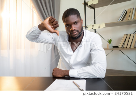Contract reject. Offer disapproval. Project failure. Dissatisfied frown business man refusing deal with thumb down bad gesture at office workplace interior. Contract reject. Offer disapproval. Project failure. Dissatisfied frown business man refusing deal with thumb down bad gesture at office workplace interior. 84170581