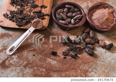 broken chocolate cocoa beans bowl rustic backdrop. High quality beautiful photo concept 84170678