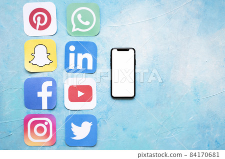 paper cut outs social media icons arranged near smartphone. High quality beautiful photo concept paper cut outs social media icons arranged near smartphone. High quality beautiful photo concept 84170681