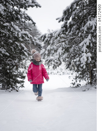 Child in winter. A little girl, playing in the winter outside. Child in winter. A little girl, playing in the winter outside. 84172400