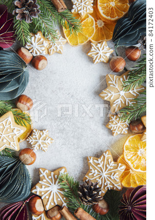 Christmas decorations with  fir branches border, gingerbread  cookies and paper baubles 84172403