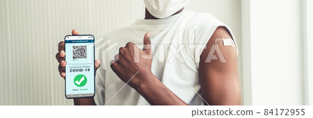 African American teenager shows vaccine passport on mobile phone African American teenager shows vaccine passport on mobile phone 84172955