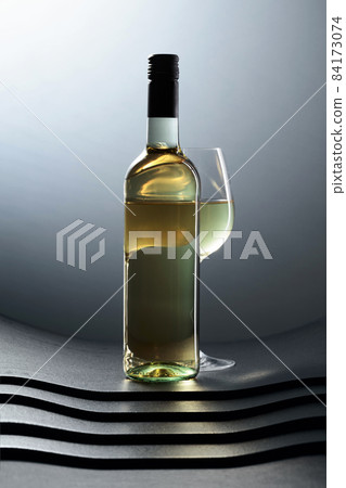 Bottle and glass of white wine. Bottle and glass of white wine. 84173074