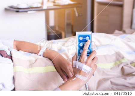 Patient woman hands using remote control for adjust level sickbed at hospital 84173510