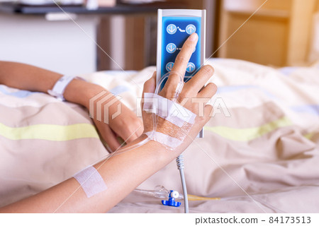 Patient hands using remote control for adjust level sickbed at hospital Patient hands using remote control for adjust level sickbed at hospital 84173513