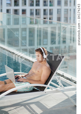 Businessman Working During Vacation Businessman Working During Vacation 84174243