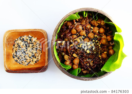 Vietnamese cuisine from red rice with sesame salt nutrition rice dish on green leaf Vietnamese cuisine from red rice with sesame salt nutrition rice dish on green leaf 84176303