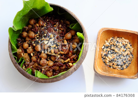 Vietnamese cuisine from red rice with sesame salt nutrition rice dish on green leaf Vietnamese cuisine from red rice with sesame salt nutrition rice dish on green leaf 84176308