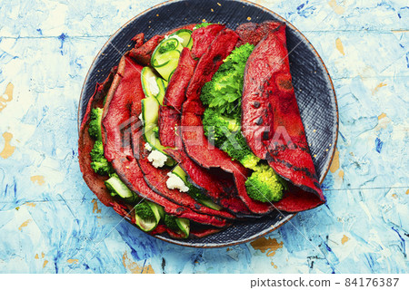 Beetroot pancakes with vegetable filling Beetroot pancakes with vegetable filling 84176387