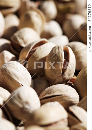 Organic pistachios in the sun, healthy food and snack background Organic pistachios in the sun, healthy food and snack background 84176819